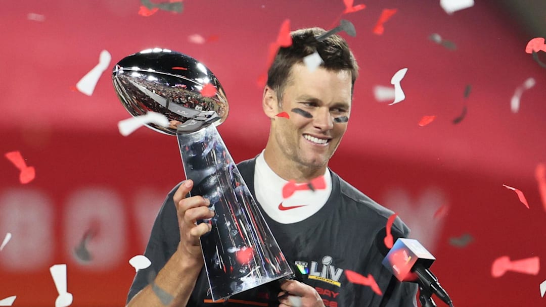 Tampa Bay Buccaneers quarterback Tom Brady (12) hoists the Vince Lombardi Trophy after defeating the Kansas City Chiefs 