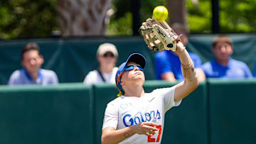 Florida Gators outfielder Kendra Falby (27) catches a fly ball in the sun. 