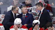 Nov 3, 2022; Winnipeg, Manitoba, CAN;  Montreal Canadiens Assistant Coach Stephane Robidas, Montreal Canadiens Head Coach Martin St. Louis and Montreal Canadiens Assistant Coach Alex Burrows discuss a play before overtime against the Winnipeg Jets at Canada Life Centre. Mandatory Credit: James Carey Lauder-Imagn Images
