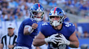 Sep 28, 2025; East Rutherford, New Jersey, USA; New York Giants running back Cam Skattebo (44) runs with the ball against the Los Angeles Chargers after taking the handoff from quarterback Jaxson Dart (6) during the fourth quarter at MetLife Stadium.  