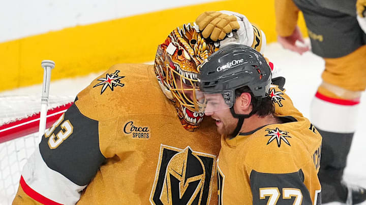 Feb 5, 2026; Las Vegas, Nevada, USA; Vegas Golden Knights center Kai Uchacz (77) congratulates goaltender Adin Hill (33) after the Golden Knights defeated the Los Angeles Kings 4-1 at T-Mobile Arena. Mandatory Credit: Stephen R. Sylvanie-Imagn Images