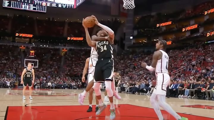 Amen Thompson grabs Giannis Antetokounmpo by the head to prevent a basket. 