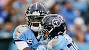 Tennessee Titans quarterback Cam Ward hands off to running back Tony Pollard.