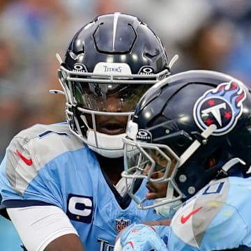 Tennessee Titans quarterback Cam Ward hands off to running back Tony Pollard.