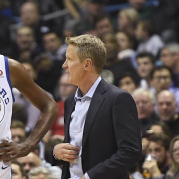 Golden State Warriors head coach Steve Kerr talks to forward Kevin Durant.
