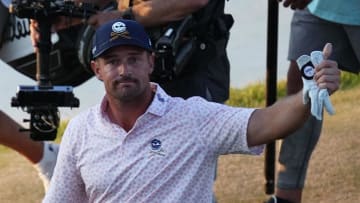 Bryson DeChambeau waves to the gallery as he walks to the 18th green during the third round of the U.S. Open golf tournament.