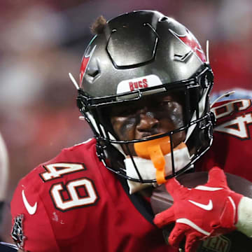 Tampa Bay Buccaneers running back Owen Wright runs with the ball as Tennessee Titans linebacker Jaylen Harrell defends.