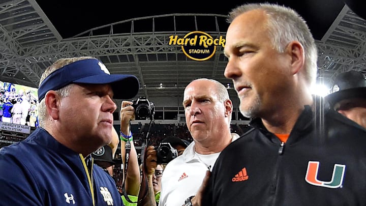 Nov 11, 2017; Miami Gardens, FL, USA; Notre Dame Fighting Irish head coach Brian Kelly (L) shakes hands with Miami Hurricanes head coach Mark Richt (R) after the Miami Hurricanes defeat the Notre Dame Fighting Irish at Hard Rock Stadium. Nov 11, 2017; Miami Gardens, FL, USA; Notre Dame Fighting Irish head coach Brian Kelly (L) shakes hands with Miami Hurricanes head coach Mark Richt (R) after the Miami Hurricanes defeat the Notre Dame Fighting Irish at Hard Rock Stadium.