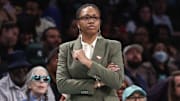Atlanta Dream head coach Tanisha Wright stands on the sidelines during the 2024 WNBA playoffs.