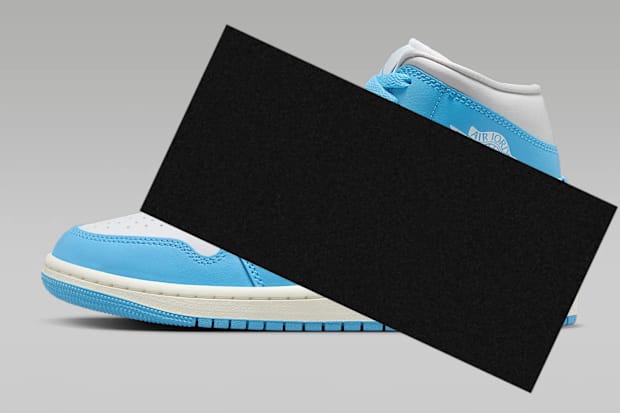 Black bar over blue and white Air Jordan sneakers.