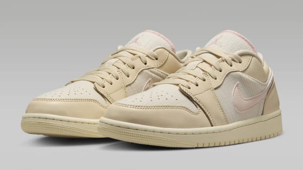 Tan and pink Air Jordan sneakers.