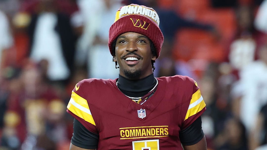 Aug 18, 2025; Landover, Maryland, USA; Washington Commanders quarterback Jayden Daniels (5) request the ball after Commanders running back Jacory Croskey-Merritt (not pictured) scores a touchdown against Cincinnati Bengals during the first half at Northwest Stadium. Mandatory Credit: Amber Searls-Imagn Images