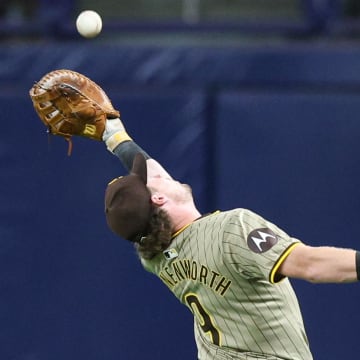 Aug 30, 2024; St. Petersburg, Florida, USA; San Diego Padres first baseman Jake Cronenworth (9) makes a catch for an out against the Tampa Bay Rays in the seventh inning at Tropicana Field. Mandatory Credit: Nathan Ray Seebeck-USA TODAY Sports