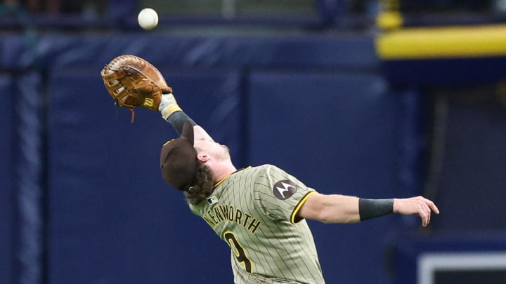 Aug 30, 2024; St. Petersburg, Florida, USA; San Diego Padres first baseman Jake Cronenworth (9) makes a catch for an out against the Tampa Bay Rays in the seventh inning at Tropicana Field. Mandatory Credit: Nathan Ray Seebeck-USA TODAY Sports