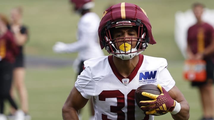 Jul 25, 2024; Ashburn, VA, USA; Washington Commanders running back Austin Ekeler (30) carries the ball during day two of Commanders training camp at OrthoVirginia Training Center at Commanders Park. Mandatory Credit: Geoff Burke-USA TODAY Sports