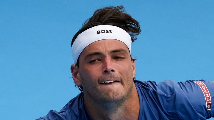 Taylor Fritz returns a shot