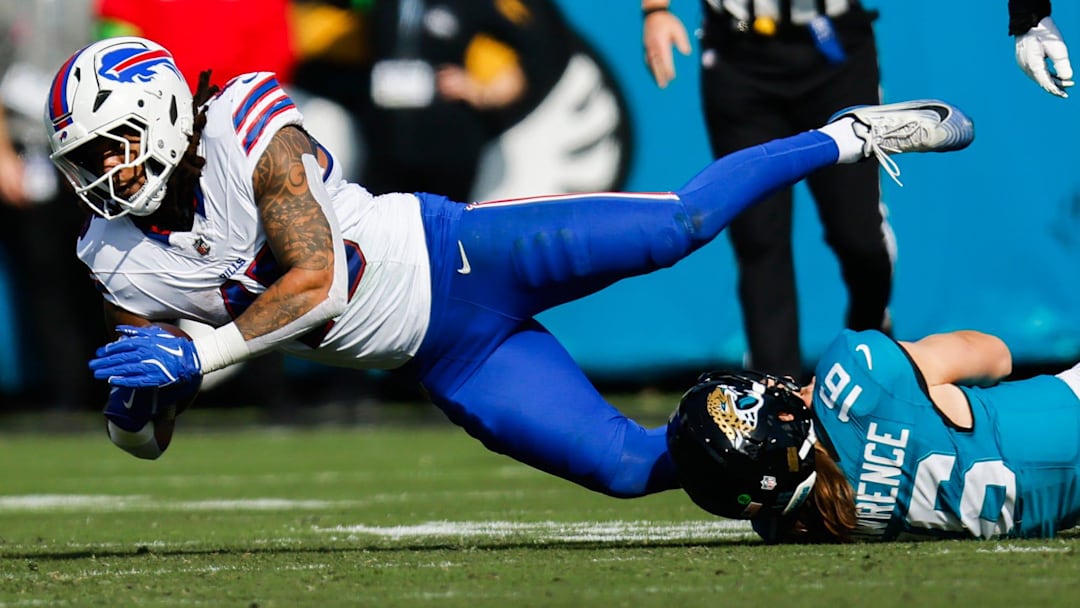 Jacksonville Jaguars quarterback Trevor Lawrence (16) tackles Buffalo Bills linebacker Shaq Thompson (45) after throwing an interception during the first quarter in an NFL football AFC Wild Card playoff matchup, Sunday, Jan. 11, 2026, in Jacksonville, Fla. Bills lead 10-7 at the half over the Jaguars. 
