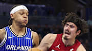 Miami Heat forward Jaime Jaquez Jr. is guarded by Orlando Magic forward Paolo Banchero.