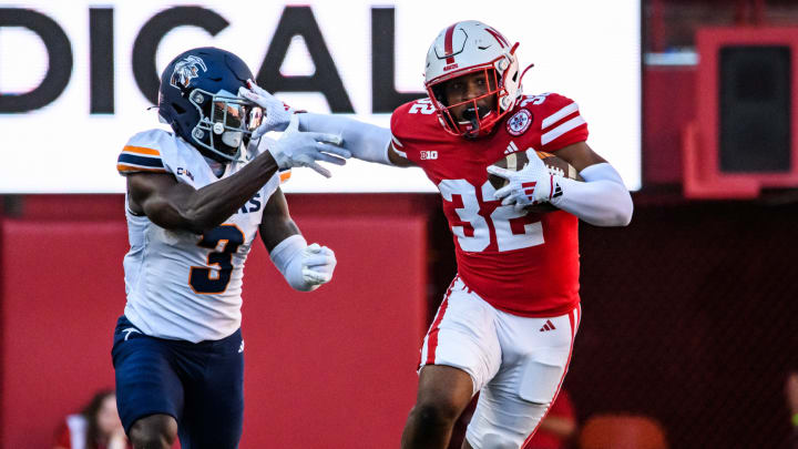 Nebraska's Rahmir Stewart stiff-arms UTEP's Jaden Smith after a fourth-quarter interception. 