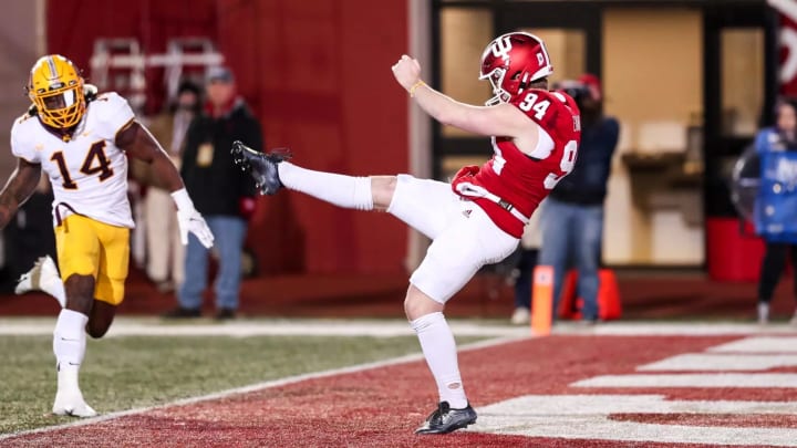 James Evans punts against Minnesota.