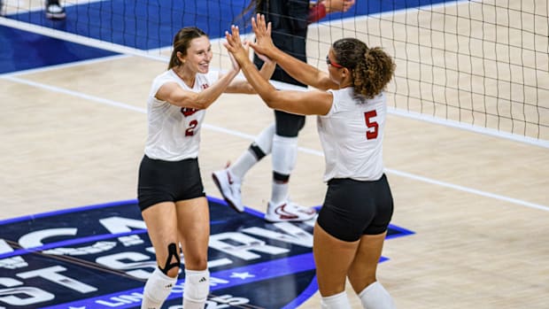 Bergen Reilly (2) and Rebekah Allick (5) high five after Allick's kill. 
