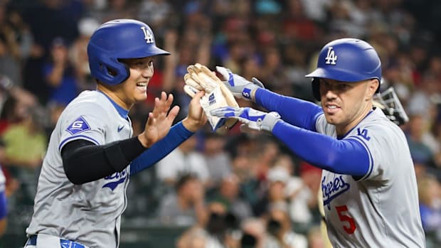 Los Angeles Dodgers designated hitter Shohei Ohtani celebrates with first baseman Freddie Freeman