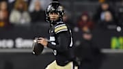 Nov 22, 2025; Boulder, Colorado, USA; Colorado Buffaloes quarterback Julian Lewis (10) scrambles in the first quarter against the Arizona State Sun Devils at Folsom Field. Mandatory Credit: Ron Chenoy-Imagn Images