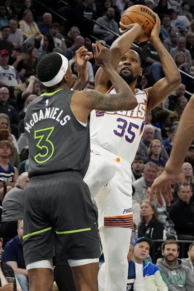 Phoenix Suns forward Kevin Durant shoots over Minnesota Timberwolves forward Jaden McDaniel