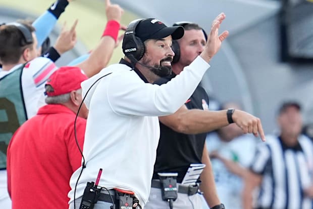 Ohio State Buckeyes head coach Ryan Day makes moves during the first half of the NCAA football game against the Oregon Ducks