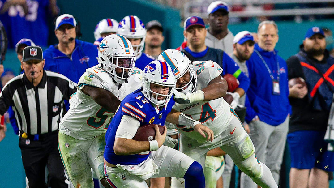 Buffalo Bills quarterback Josh Allen (17), runs by several Dolphins defenders on his way to a first down, during second half action of their NFL football game last January.