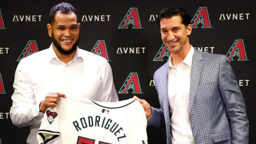 Arizona Diamondbacks starting pitcher Eduardo Rodriguez holds up his jersey with GM Mike Hazen