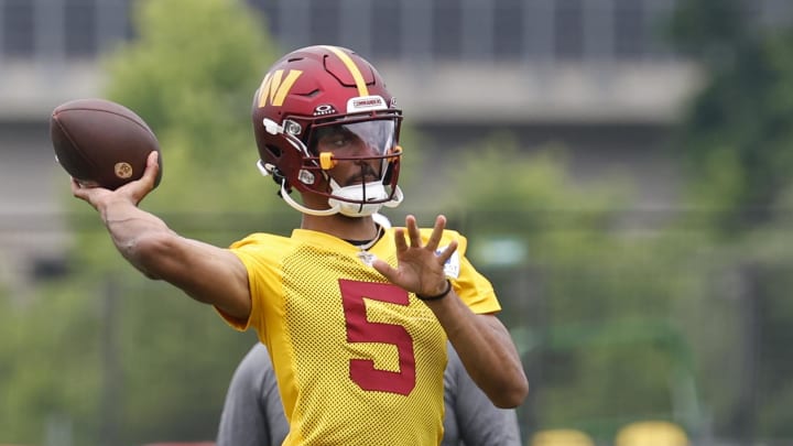 Jun 5, 2024; Ashburn, VA, USA; Washington Commanders quarterback Jayden Daniels (5) prepares to pass a ball during an OTA workout at Commanders Park. Mandatory Credit: Geoff Burke-USA TODAY Sports