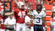 Nebraska Cornhuskers fullback Sam Hill pleads to the official as Nevada Wolf Pack cornerback Paul Pratt looks skyward as the official called another pass interference on the Wolf Pack in the first quarter at Memorial Stadium. Nebraska won 52-10.