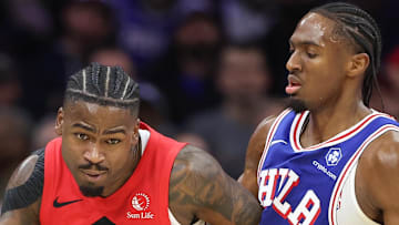Toronto Raptors guard Jamal Shead dribbles the ball against Philadelphia 76ers guard Tyrese Maxey.