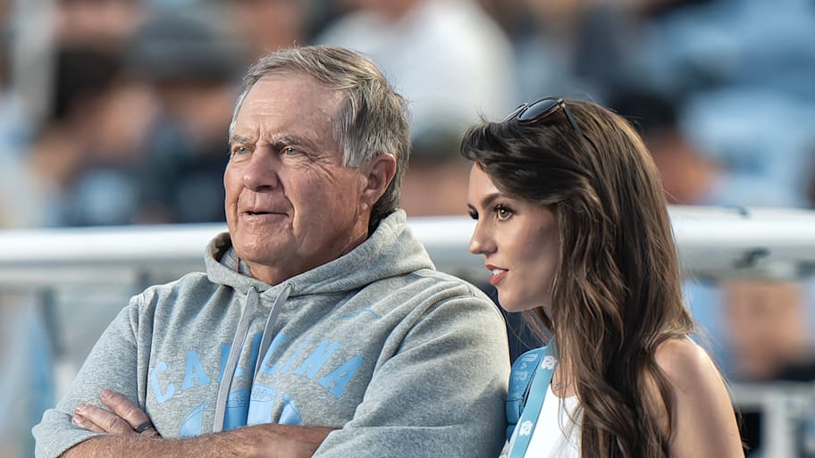 Bill Belichick and his girlfriend, Jordon Hudson, stand on the sideline before the game against TCU.
