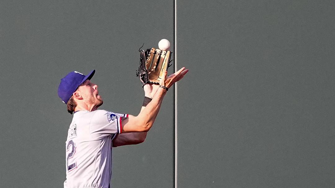 June 10, 2026; Kansas City, Missouri, USA; Texas Rangers center fielder Evan Carter (32) catches a long fly ball against the Kansas City Royals during the third inning at Kauffman Stadium. Mandatory Credit: Denny Medley-Imagn Images