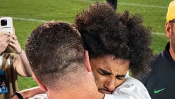 Oregon head coach Dan Lanning, left, embraces Oregon quarterback Dante Moore after the Ducks’ win as the Oregon Ducks face the Penn State Nittany Lions on Sept. 27, 2025, at Beaver Stadium in University Park, Pennsylvania.