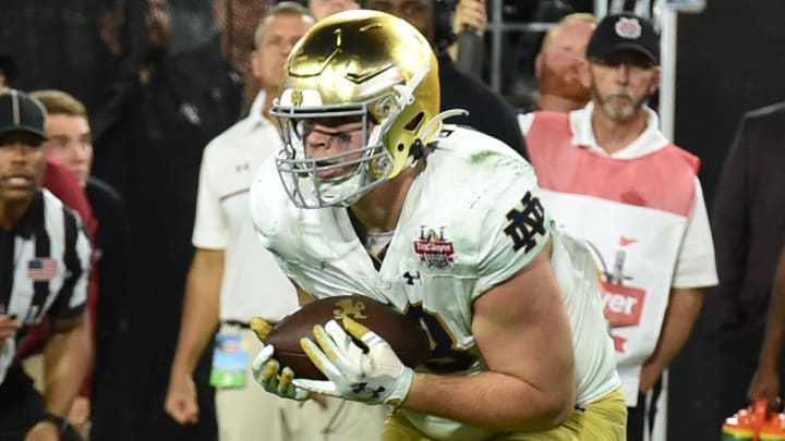 Notre Dame Fighting Irish tight end Mitchell Evans (88) pulls in a pass that he took to the end zone for the game winning touchdown with just over a minute and a half to play in the game. The University of Notre Dame Fighting Irish took on the University of South Carolina Gamecocks in the TaxSlayer Gator Bowl game in Jacksonville, Florida's TIAA Bank Field Friday, December 30, 2022. The first half ended with South Carolina holding a 24 to 17 lead but Notre Dame came back and with a late fourth