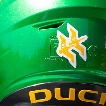 An decal in recognition of former Oregon defensive back Khyree Jackson and tight end Spencer Webb adorns helmets during the Ducks’ fall camp Tuesday, Aug. 6, 2024, at the Hatfield-Dowlin Complex in Eugene, Ore.