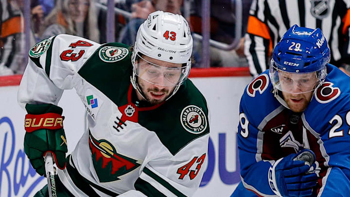 May 13, 2026; Denver, Colorado, USA; Minnesota Wild defenseman Quinn Hughes (43) controls the puck under pressure from Colorado Avalanche center Nathan MacKinnon (29) in the third period in game five of the second round of the 2026 Stanely Cup Playoffs at Ball Arena. Mandatory Credit: Isaiah J. Downing-Imagn Images