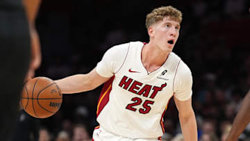 Oct 8, 2025; Miami, Florida, USA;  Miami Heat guard Kasparas Jakucionis (25) looks to pass the ball as San Antonio Spurs forward Harrison Barnes (40) defends in the first half at Kaseya Center. Mandatory Credit: Jim Rassol-Imagn Images