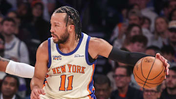 New York Knicks guard Jalen Brunson looks to drive past Toronto Raptors guard Jamal Shead.
