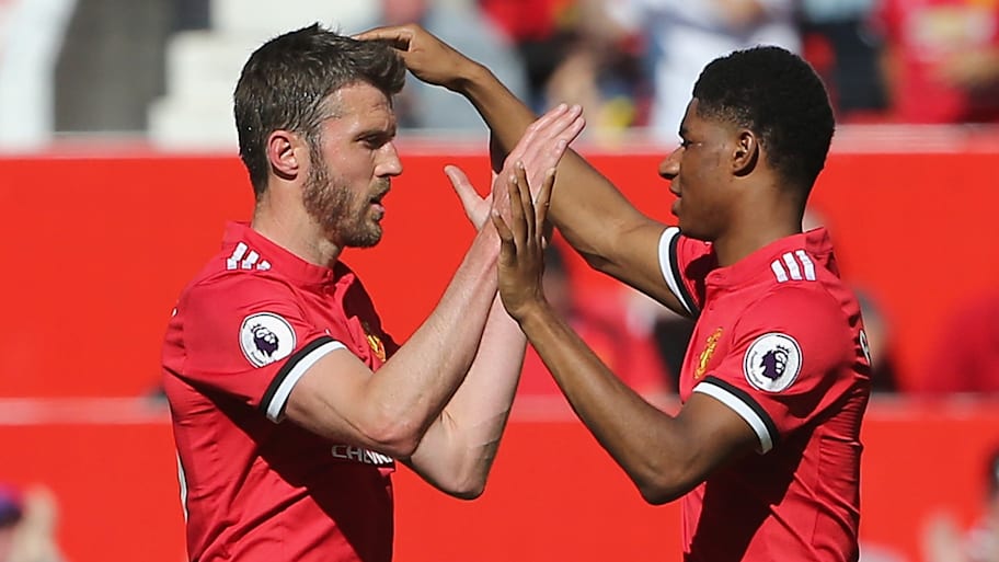 Michael Carrick (left) and Marcus Rashford.
