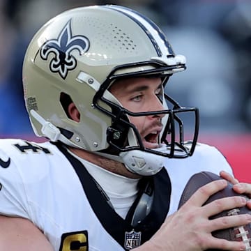 Dec 8, 2024; East Rutherford, New Jersey, USA; New Orleans Saints quarterback Derek Carr (4) drops back to pass against the New York Giants during the first quarter at MetLife Stadium. Mandatory Credit: Brad Penner-Imagn Images