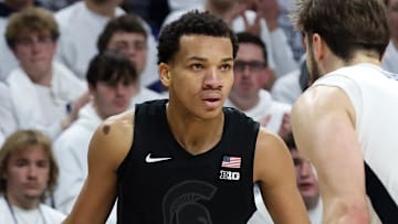 Dec 13, 2025; University Park, Pennsylvania, USA; Michigan State Spartans guard Divine Ugochukwu (99) looks to move the ball around Penn State Nittany Lions forward Ivan Juric (3) during the second half at Bryce Jordan Center. Mandatory Credit: Matthew O'Haren-Imagn Images