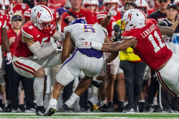 Nebraska defenders John Bullock and Cameron Lenhardt combine to bring down Northern Iowa running back Amauri Pesek-Hickson.