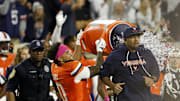 Oct 18, 2025; Charlottesville, Virginia, USA; Virginia Cavaliers head coach Tony Elliott is dumped with water from a cooler by Cavaliers safety Antonio Clary 
(0) in celebration after the final play against the Washington State Cougars at Scott Stadium. Mandatory Credit: Geoff Burke-Imagn Images