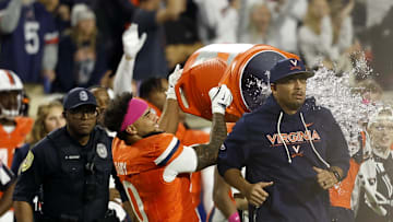 Oct 18, 2025; Charlottesville, Virginia, USA; Virginia Cavaliers head coach Tony Elliott is dumped with water from a cooler by Cavaliers safety Antonio Clary 
(0) in celebration after the final play against the Washington State Cougars at Scott Stadium. Mandatory Credit: Geoff Burke-Imagn Images