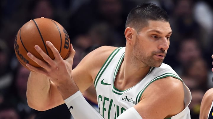 Feb 25, 2026; Denver, Colorado, USA; Boston Celtics center Nikola Vucevic (4) works in the post against Denver Nuggets guard Julian Strawther (3) during the first half at Ball Arena. Mandatory Credit: Christopher Hanewinckel-Imagn Images