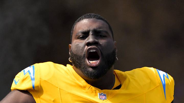 Los Angeles Chargers guard Mekhi Becton runs onto the field